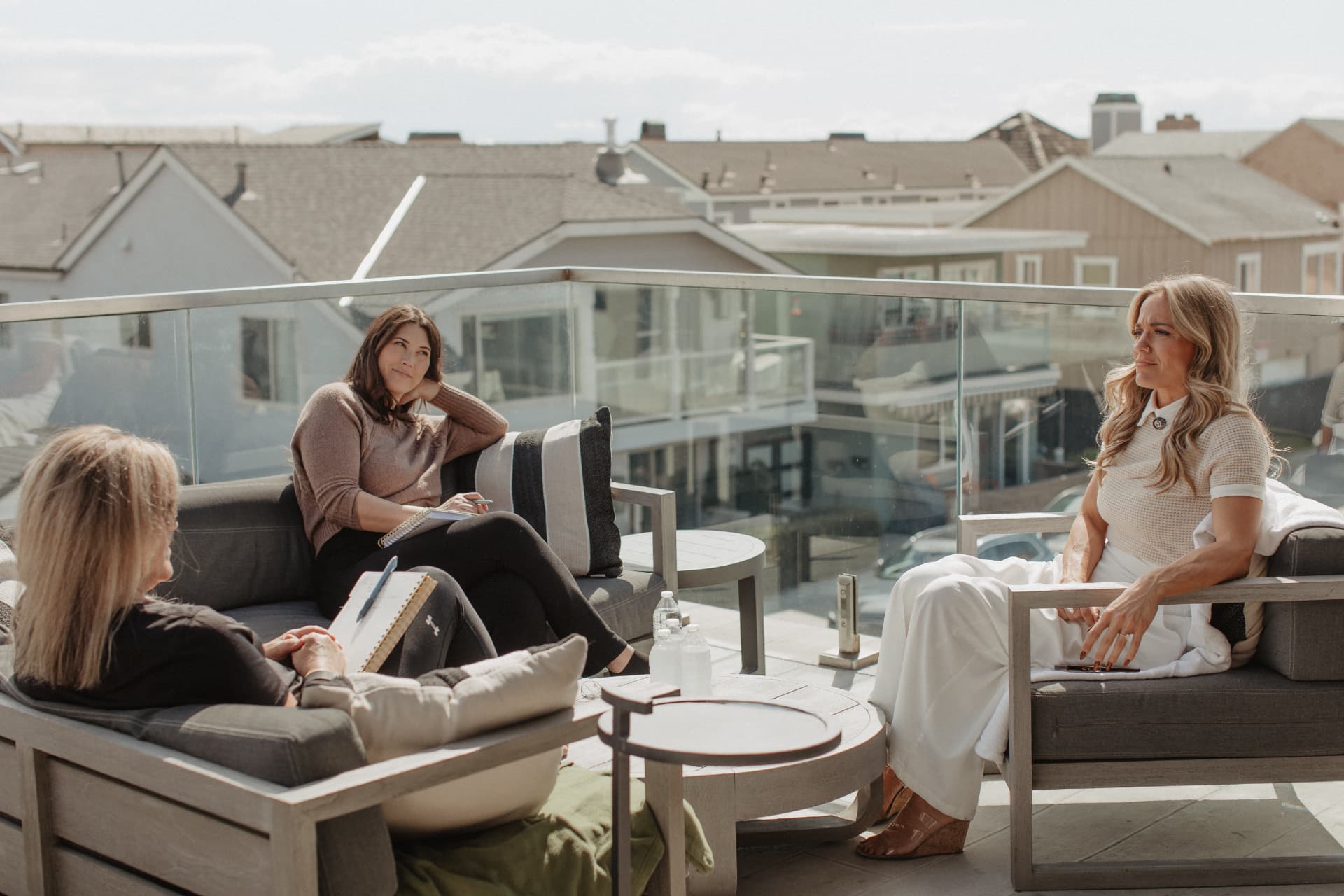 Molly Gomez leading a rooftop discussion with Inner Circle members in Newport Beach
